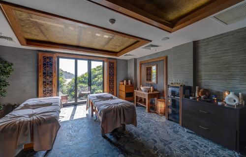 a large room with two beds and a window at Angel's Marmaris Hotel in Turgut