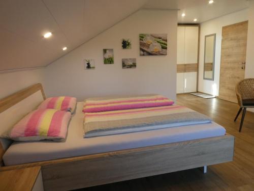a bed with two pillows on it in a room at Privatpension Eberth in Bogen