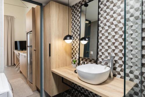 a bathroom with a sink and a mirror at Urban loft II in Thessaloniki