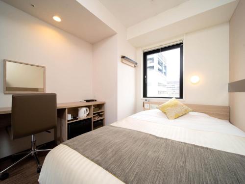 Postel nebo postele na pokoji v ubytování Super Hotel Tokyo Hamamatsucho