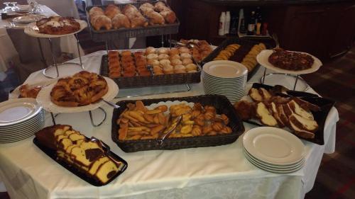 a table topped with lots of different types of food at Hotel Meida in Pozza di Fassa