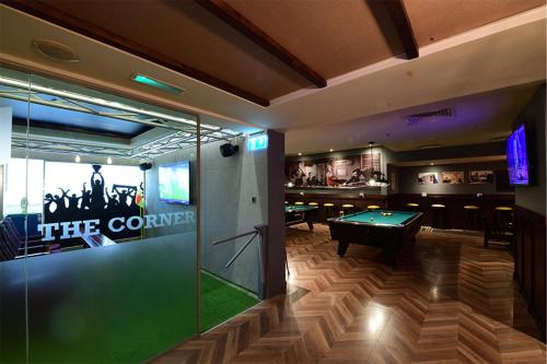a bar with a ping pong table in a room at Majestic City Retreat Hotel in Dubai