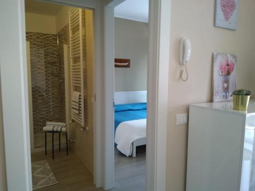 a room with a bedroom with a bed and a phone at Danilo Apartments in Baveno