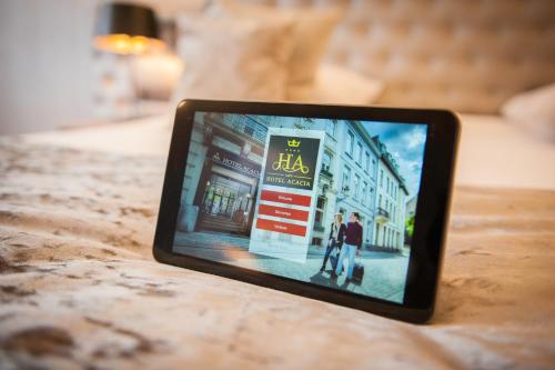 a tablet sitting on top of a table at Hotel Acacia in Bruges