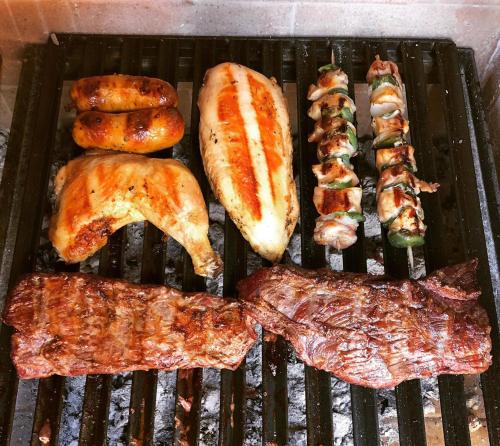 a grill with a bunch of different types of food at Balcones al Nahuel II in San Carlos de Bariloche
