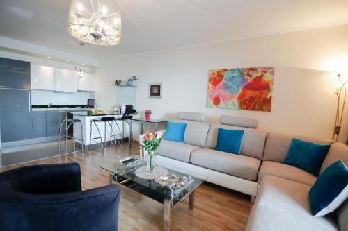 a living room with a couch and a table at Sea view luxury apartment in Saint-Laurent-du-Var
