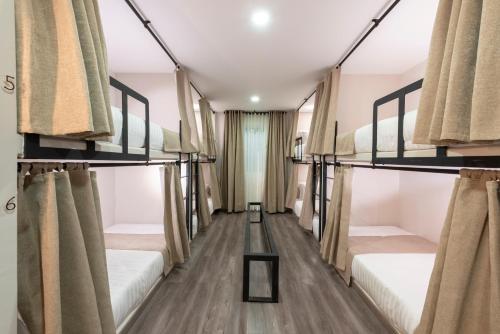 a room with four bunk beds with curtains at Medellín Vibes Hostel in Medellín