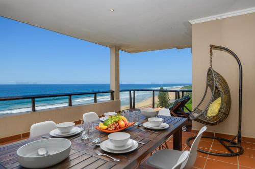 a dining room with a table and chairs and the ocean at Sunrise Beach View in Westbrook