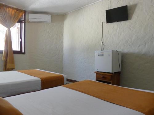 Ένα ή περισσότερα κρεβάτια σε δωμάτιο στο Hostal Estrella de Mar