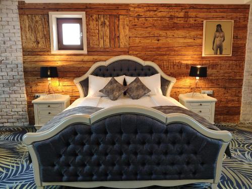a bedroom with a large bed with two night stands at ART Hotel in Sibiu