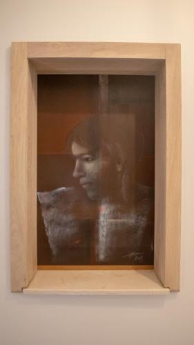 a painting of a woman in a wooden frame at ART Hotel in Sibiu