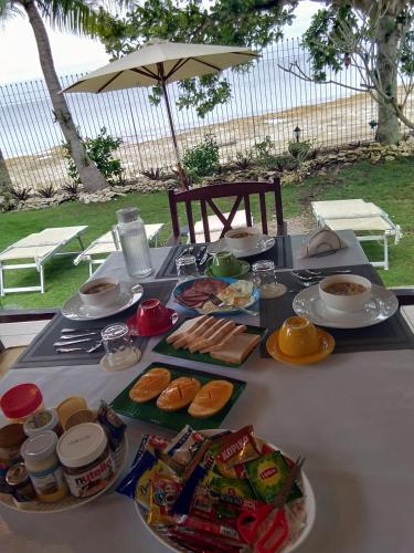 a table with plates of food on top of it at Ancelle Cristo Re in Moalboal