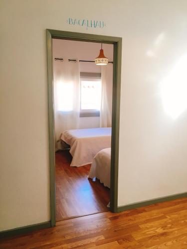 a mirror in a room with a bed at Eskama guest house in Esposende