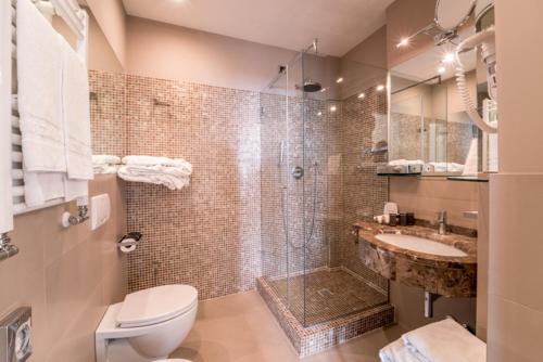 a bathroom with a shower and a toilet and a sink at Terrazza Marconi Hotel&Spamarine in Senigallia