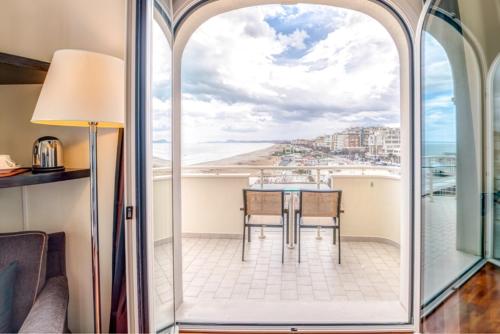 a dining room with a table and a view of the ocean at Terrazza Marconi Hotel&Spamarine in Senigallia