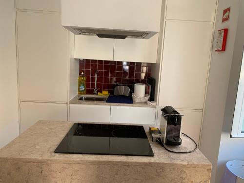 a kitchen with a counter top with a phone on it at Apartments Alfacinha Ajuda in Lisbon