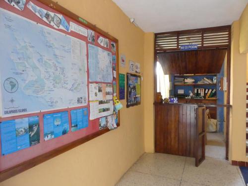 a classroom with a large map on the wall at Hostal Estrella de Mar in Puerto Ayora