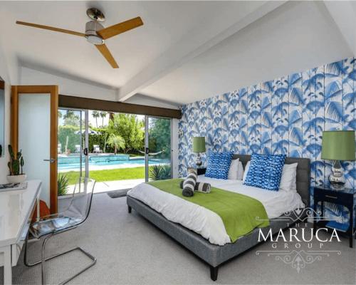a bedroom with a bed with blue and white wallpaper at Villa Finola in Palm Springs