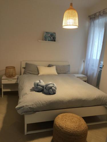 a bedroom with a bed with two pillows on it at Casa Levante in Gaeta