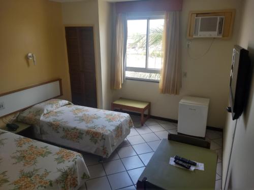 Ένα ή περισσότερα κρεβάτια σε δωμάτιο στο Nascimento Praia Hotel