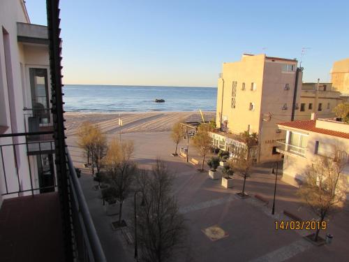 a view of the beach from a balcony of a building at Cal Xillo in Torredembarra