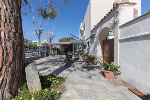 a walkway with a bench and a building at Masseria Sant'Anna in Bari