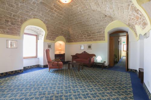 a living room with a couch and chairs in a room at Masseria Sant'Anna in Bari