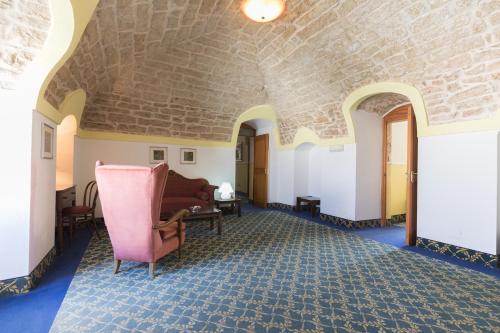 a living room with a couch and a chair at Masseria Sant'Anna in Bari