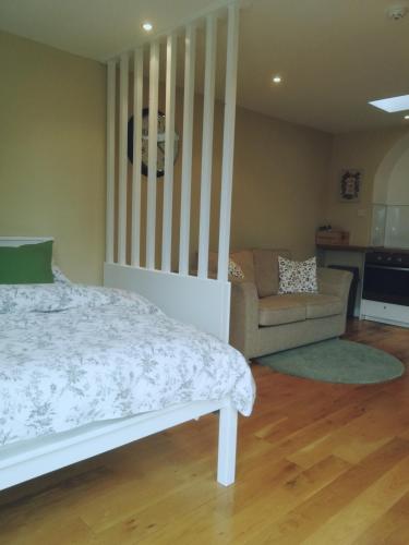 a bedroom with a bed and a couch at The Village Rooms in Dundalk