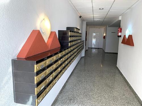 a hallway in a building with boxes on the wall at Apartamento 1ª Linea de Mar -WIFI- Aire Acondicionado in Empuriabrava
