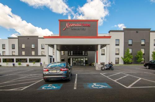 a car parked in a parking lot in front of a hospital at Holiday Inn & Suites Syracuse Airport - Liverpool by IHG in Liverpool