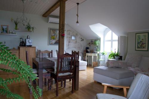 a living room with a table and a dining room at Kuressaare Romantic Apartment in Kuressaare