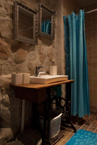 a bathroom with a sink and a shower at Kuressaare Romantic Apartment in Kuressaare