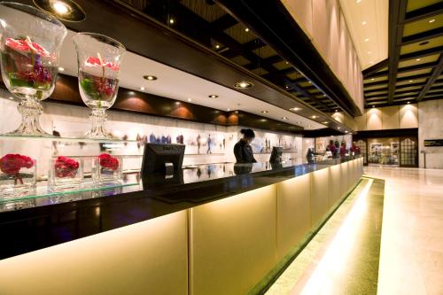 a long counter in a store with wine glasses at Southern Sun Cape Sun in Cape Town