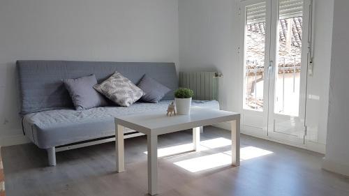 a living room with a couch and a table at Casa Botes in Cuenca