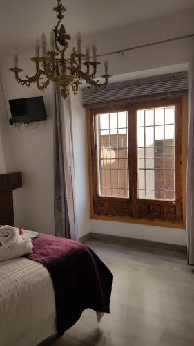 a bedroom with a bed and a large window at Casa Botes in Cuenca
