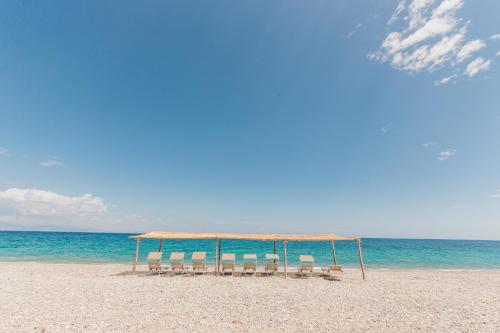 a group of chairs and a canopy on a beach at Casa Solares in Solfara Mare