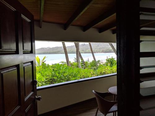 a room with a balcony with a view of the ocean at La Sagesse Hotel, Restaurant and Beach Bar in Content