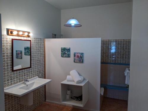 a bathroom with a sink and a shower at La Sagesse Hotel, Restaurant and Beach Bar in Content