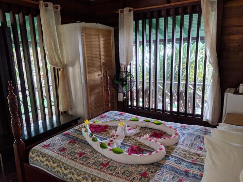 a room with a bed with a cake on it at La Sagesse Hotel, Restaurant and Beach Bar in Content