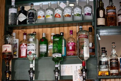 a bar with a bunch of bottles of alcohol at The Kirkmichael Hotel in Kirkmichael