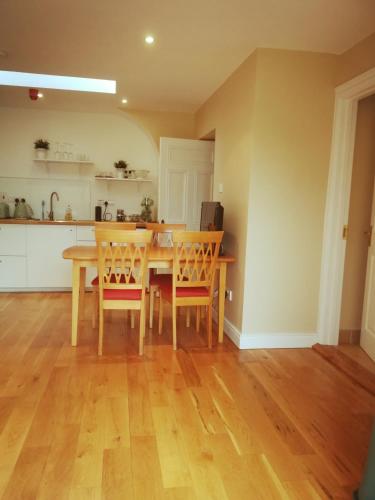 a kitchen and dining room with a table and chairs at The Village Rooms in Dundalk