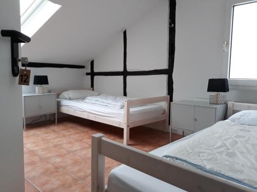 a bedroom with two beds and two night stands at Hostel 45 in Bonn