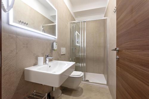a bathroom with a sink and a toilet and a shower at S. Martino Rooms in Pula
