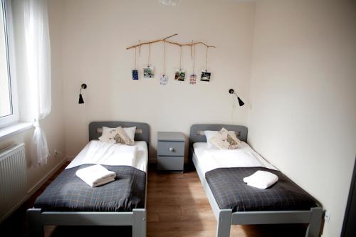 a room with two beds with towels on them at MSapartamenty in Poznań