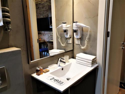 a bathroom with a sink and a mirror at SleepWell Apartments Ordynacka in Warsaw
