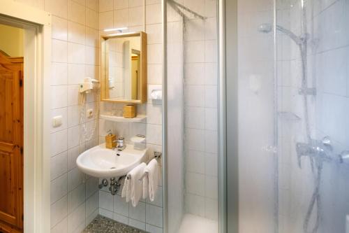 a bathroom with a sink and a shower at Rosi Boutique Hotel in Regensburg