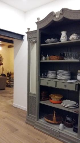 a shelf with plates and dishes in a room at Mazet Des Artistes in Mouriès