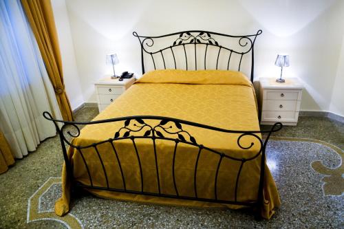 a bedroom with a bed and two night stands at B&B Lepanto in Messina