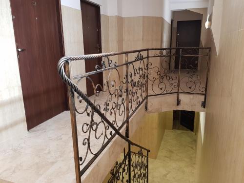 a staircase with a metal railing in a building at Marcus in Bydgoszcz